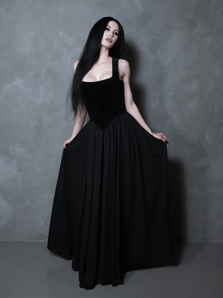 A female model channels Victorian goth romance in a luxurious black velvet Countess Corset, embodying pure dark elegance.