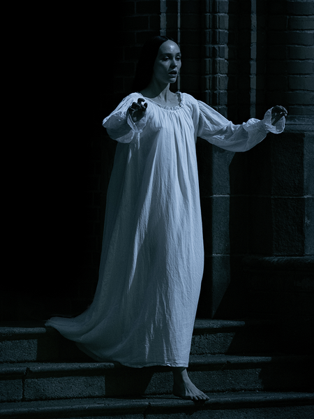 The Nosferatu Sleeping Dress evokes vintage charm with its ivory hue, delicate accents, and flowing silhouette, perfect for serene evenings.