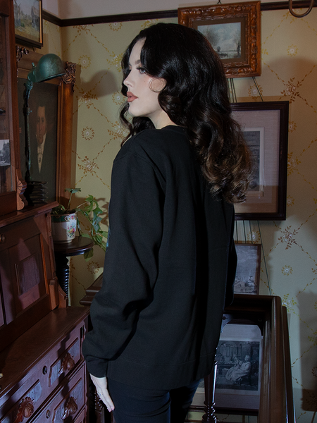 Envelop yourself in timeless gothic allure with this sweatshirt. The Nosferatu castle design on rich black fabric evokes chilling yet cozy sophistication.