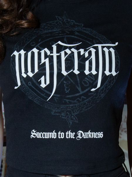 Step into shadows with this fitted tee, adorned with Nosferatu's iconic imagery. A gothic must-have, its timeless black hue suits any nocturnal ensemble.
