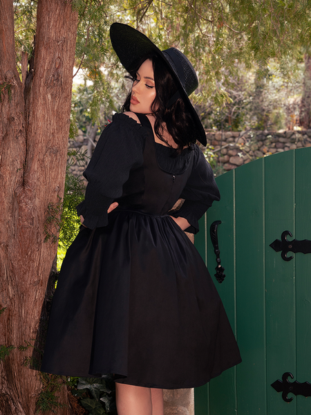 Its smocked texture and gentle volume dance with the spirit of forgotten tales.