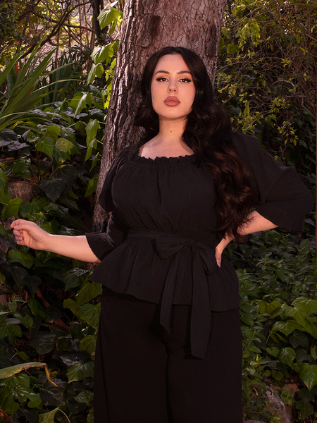 Evoking a mystic’s garment, the Ritual Peasant Top blends dark romance with relaxed sophistication.