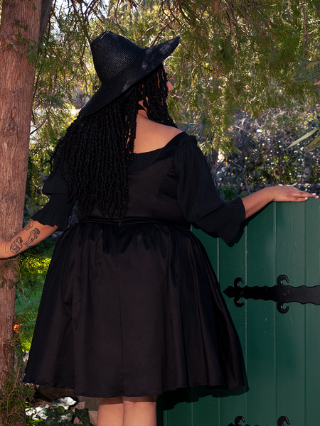 Lace trim lines the sleeves like sacred sigils, delicate and dark as forgotten hymns.