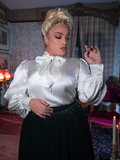 Sleeve close-up, sheer puffed elegance adorned with pearl buttons, where every stitch tells a story of bygone romance.