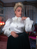 Bathed in candlelight, the blouse glows like bone china—delicate, regal, and stitched with whispers from another century.