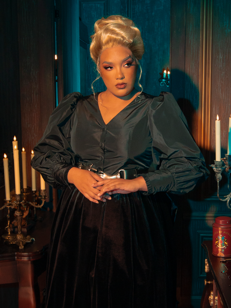 Exuding gothic elegance, female models strike various poses while showcasing the Taffeta Edwardian Blouse in Black.