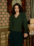 Designed for cool autumn days and poetic nights, this fitted knit cardigan in hunter green offers warmth, grace, and the perfect touch of gothic sophistication.