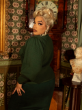 Wrap yourself in gothic elegance with this Victorian-inspired knit cardigan. A high collar, bishop sleeves, and rich hunter green hue create a truly regal aesthetic.