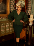 Gothic glamour meets vintage warmth in this beautifully textured knit cardigan. Its hunter green hue and intricate sleeve details create an air of antique allure.