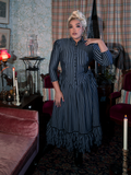 A vision of gothic beauty, the Victorian Dress in Black and Gray Stripes showcases intricate lace accents, a regal high collar, and a sweeping skirt for a striking, vintage-inspired ensemble.
