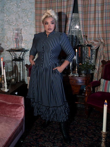 The Victorian Dress in Black and Gray Stripes blends gothic romance with classic Victorian fashion, boasting puffed sleeves, a high collar, and cascading layers of fabric for a dramatic effect.