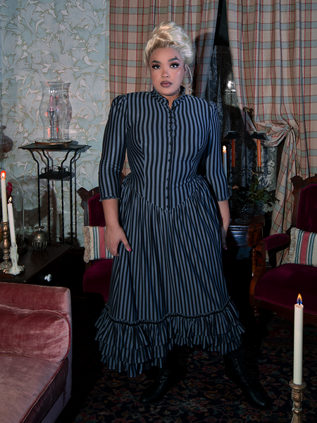 Channel 19th-century refinement in the Victorian Dress in Black and Gray Stripes, designed with a fitted waist, elegant button details, and a flowing skirt that moves with haunting grace.