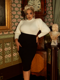 This Victorian cycling sweater in ivory is a wardrobe essential, offering soft warmth, a high collar, and elegant detailing for a touch of old-world sophistication.