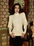 With a soft, structured silhouette, this ivory cycling pullover embodies Victorian grace, designed for movement while maintaining an air of refined elegance.