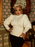 Ride with refined grace in this Victorian-inspired ivory pullover, crafted from a soft knit with bishop sleeves and a fitted waist for a perfect vintage silhouette.