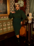 Embody regal refinement in this hunter green pullover—its soft knit, puffed shoulders, and high-neck detail make it a gothic dream for chilly days.
