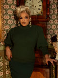 Ride in style with this Victorian-inspired pullover, crafted in a deep hunter green knit. Its puffed sleeves and tailored fit evoke vintage sophistication.