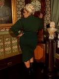 A wardrobe essential for gothic romantics, this hunter green pullover boasts a timeless high neckline, flowing bishop sleeves, and an air of old-world intrigue.