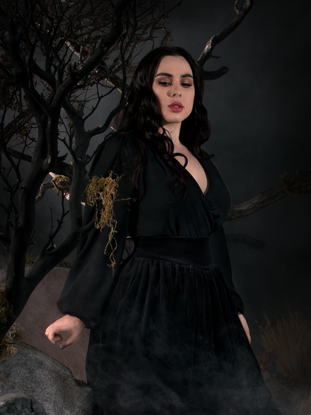 Side shot of Rachel showing off the Georgette Wrap Top in Black.