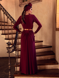 A back view of Aliza, standing on the staircase of a palatial home, models the Art Deco ruched gown in crimson from La Femme En Noir.