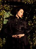 Micheline Pitt dressed all in black including the Victorian Blouse in Black from La Femme en Noir.