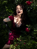 Micheline Pitt wearing the  Baudelaire Wiggle Dress in Oxblood from gothic clothing company La Femme en Noir.