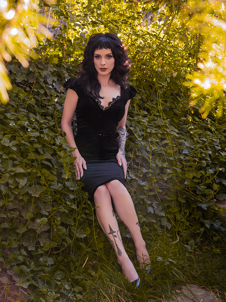 Stephanie stares directly into the camera while wearing an all new goth style dress from La Femme en Noir - the Baudelaire Wiggle Dress in Black.