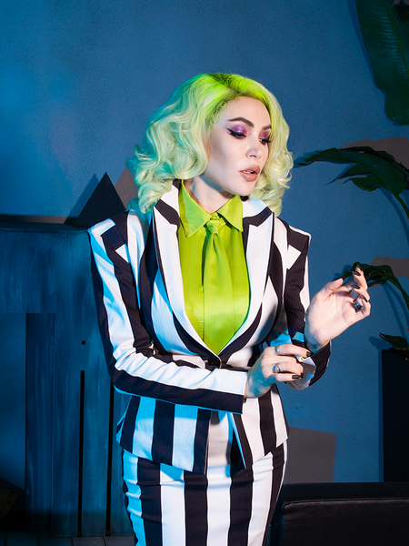 The BEETLEJUICE™ Striped Corset Blazer balances edgy detail and gothic tailoring, with bold stripes perfect for midnight jaunts.