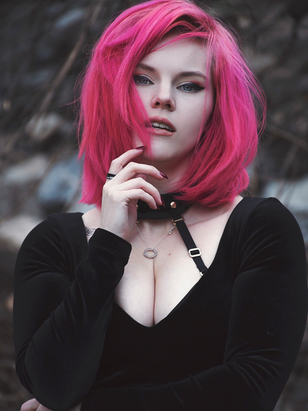 A closeup shot of Mackenzie modeling the Black Marilyn gown in black paired with a harness.