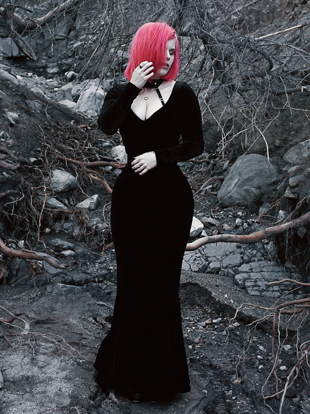 A full length shot of Mackenzie modeling the Black Marilyn gown in black paired with a harness.