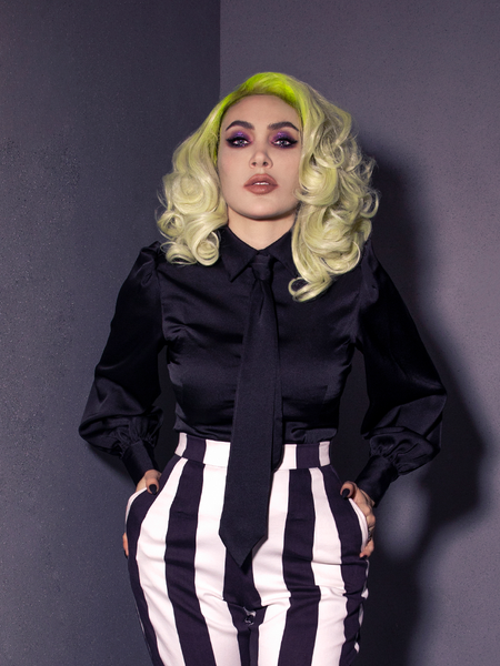 The Bowie Blouse w/Matching Tie in Black Charmeuse from La Femme en Noir being worn by brand co-owner Micheline Pitt.