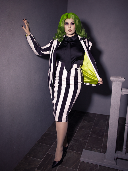 Full length shot of female model wearing a black and white striped jacket/skirt outfit with the Bowie Blouse w/Matching Tie in Black Charmeuse.