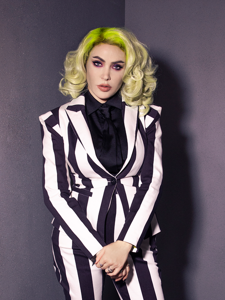 Micheline looks directly at the camera with her hands held in front of her while modeling the Bowie Blouse w/Matching Tie in Black Charmeuse.