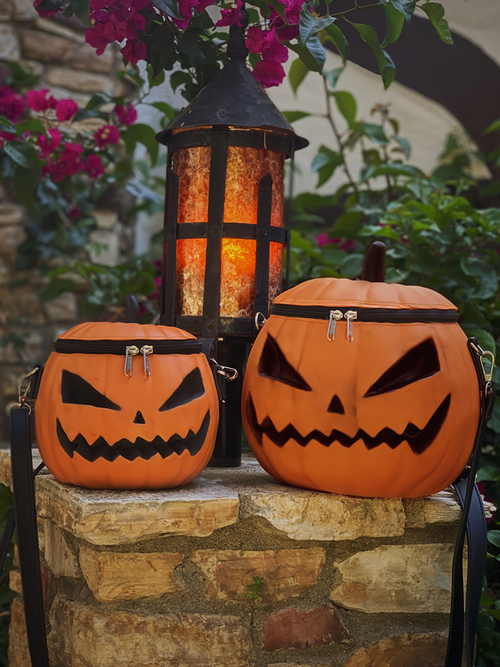 The regular size pumpkin bag and petite pumpkin bag sitting on top of a stone column.