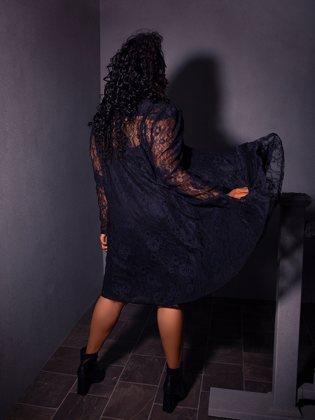 The BEETLEJUICE™ Darkroom Dress from gothic fashion brand La Femme en Noir complements the beauty of this model flawlessly.