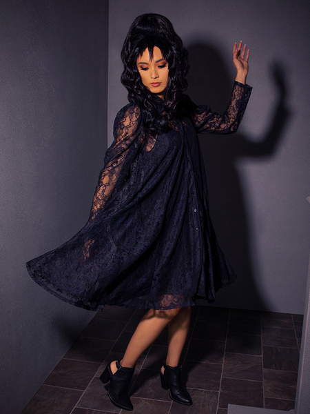 This beautiful female model effortlessly pulls off the La Femme en Noir's BEETLEJUICE™ Darkroom Dress.