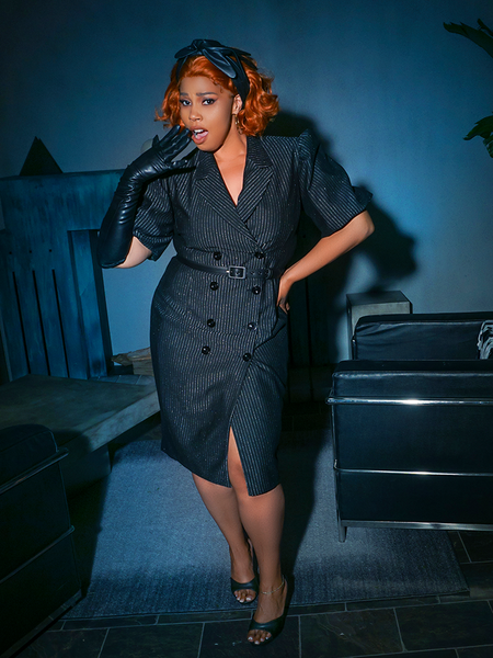 Full length shot of female model gasping with one hand held to her mouth and the other on her hip. - BEETLEJUICE™ Delia Dress