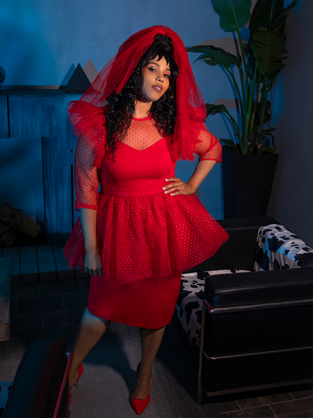 Model poses with her hand on her hip while wearing the BEETLEJUICE™ Lydia Dress from La Femme en Noir.