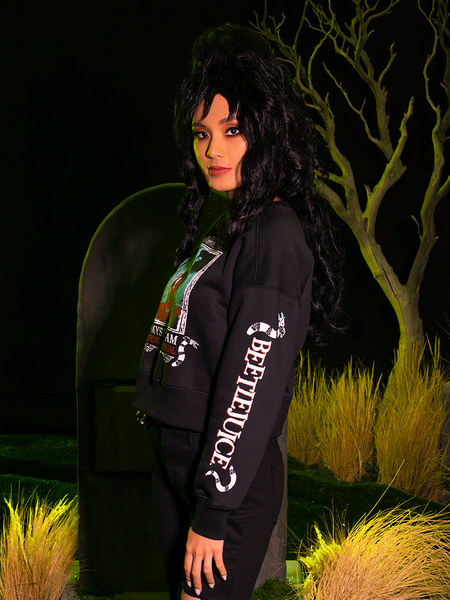 Profile shot of female model wearing the BEETLEJUICE™ Lydia Strange Long Sleeve Tee.