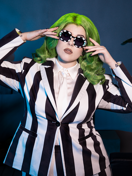 Command the room in the BEETLEJUICE™ Striped Corset Blazer. Its gothic tailoring, iconic stripes, and corset accents make it a hauntingly bold choice.