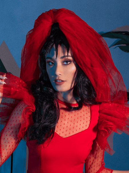 Female model posing in an all-red outfit highlighted by the Tulle Veil in Red.