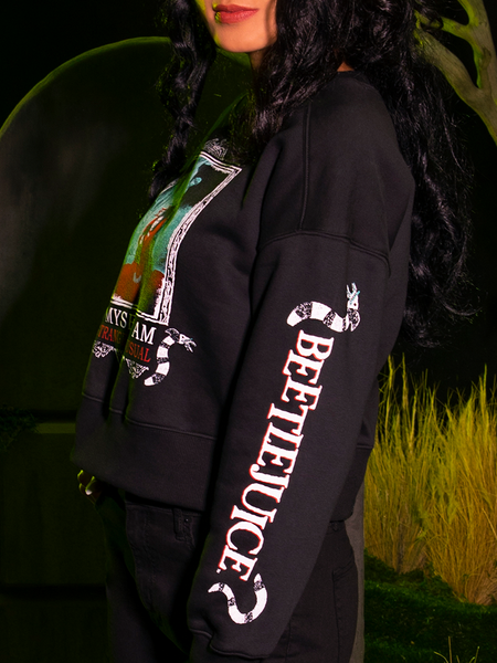 Profile shot of a model wearing the BEETLEJUICE™ Lydia Strange Long Sleeve Tee.