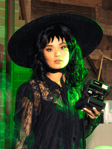 Female model channels her inner Lydia while modeling the Lydia Sun Hat along with black goth dress from La Femme en Noir.