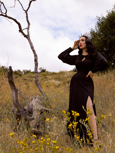 Micheline Pitt, channeling her inner Morticia Addams in the Opera Satin Gown in Black from La Femme en Noir.