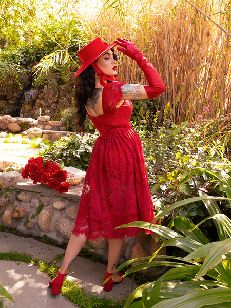 Micheline Pitt posing to show off the back of her goth style clothing.