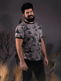 Looking into the camera while standing in a foggy forest setting, R.H. Norman models the Sleepy Hollow™ Toile Ringer Tee by La Femme En Noir.