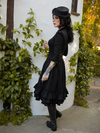 Profile shot of the Victorian Dress in Black being worn by model.