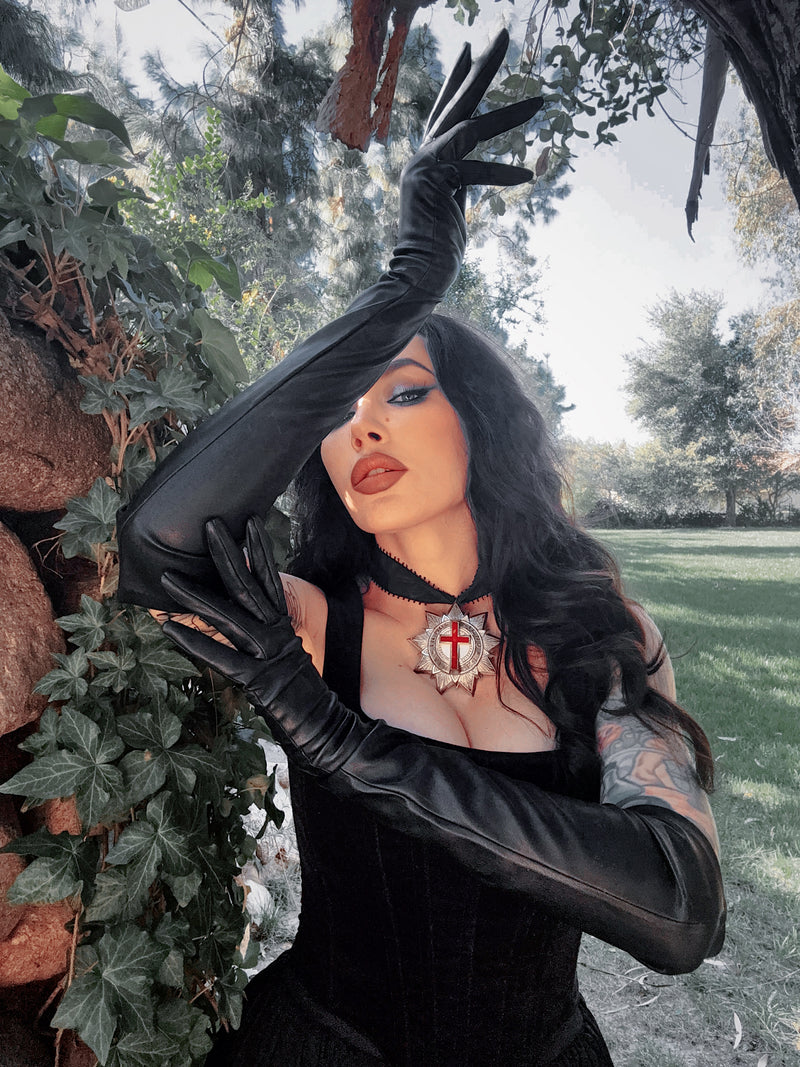 The buttery-soft vegan leather reflects a subtle, matte sheen, capturing the high-end essence of gothic glamour and sophisticated noir style.