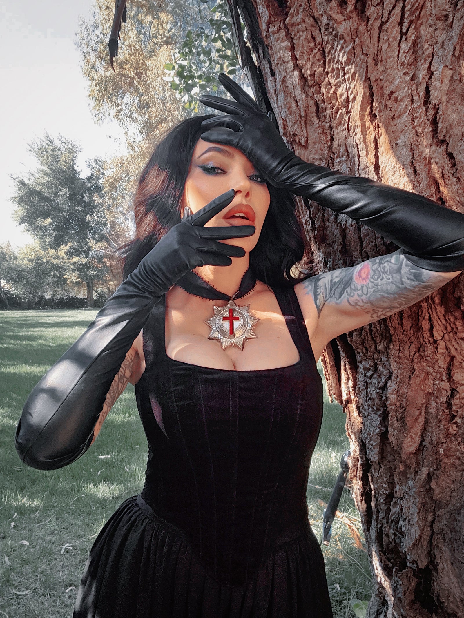 A gloved hand held in a dramatic, theatrical pose, evoking the timeless allure of a vintage film noir starlet with a gothic twist.