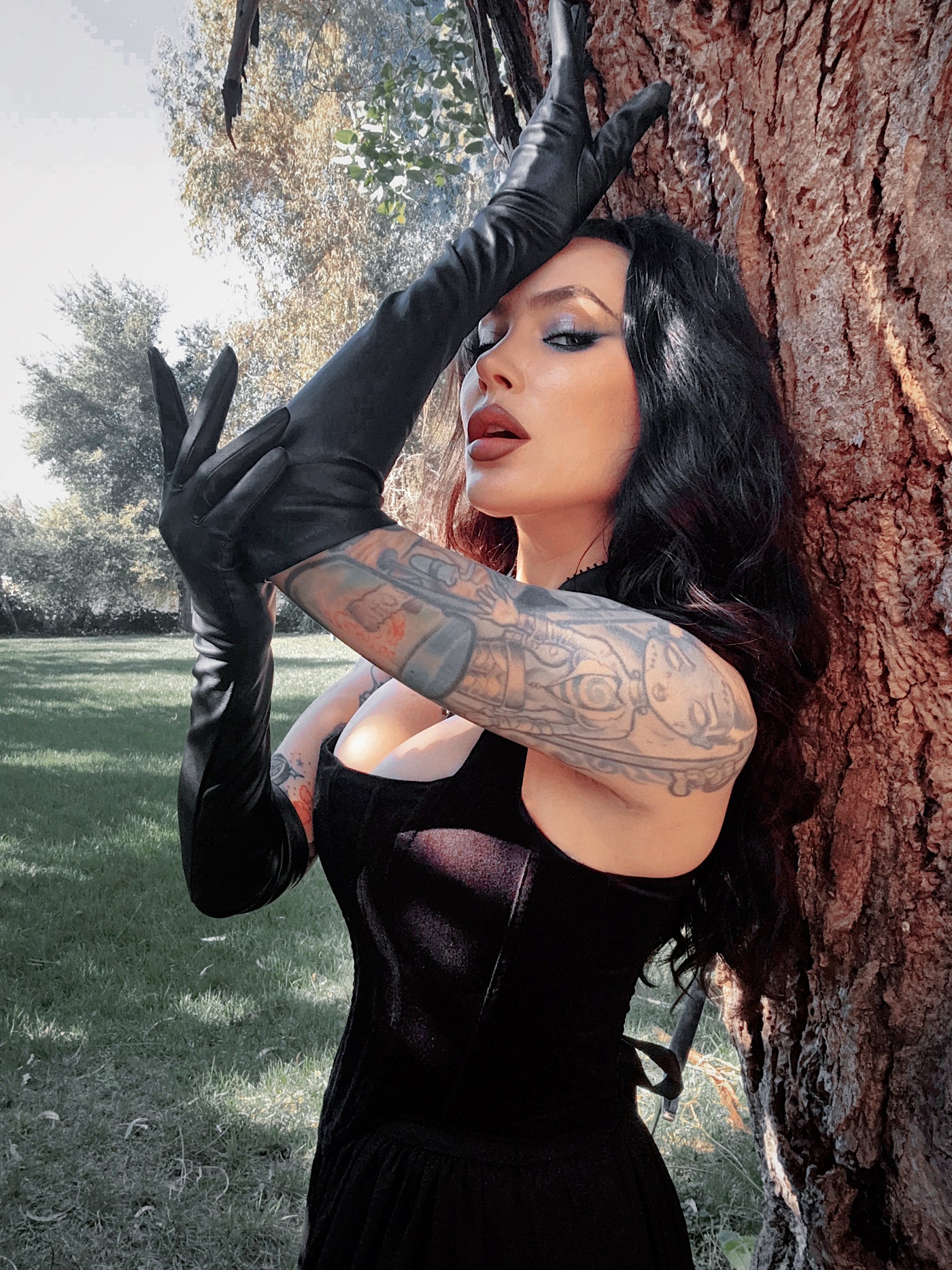 Ornate silver rings are worn over the black faux leather, a striking Whimsigoth detail that merges occult charm with dark glamour.
